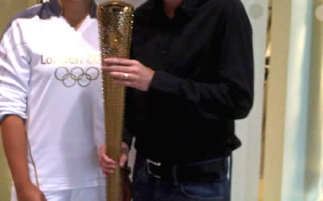 Adrian Sheehan holds the 2012 Olympic Torch