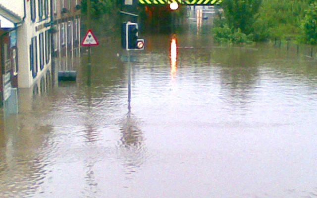 Road and buildings submerged under flood water